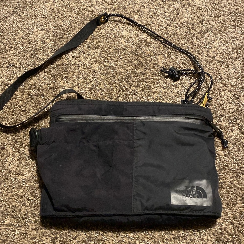 North Face black over the shoulder bag.
